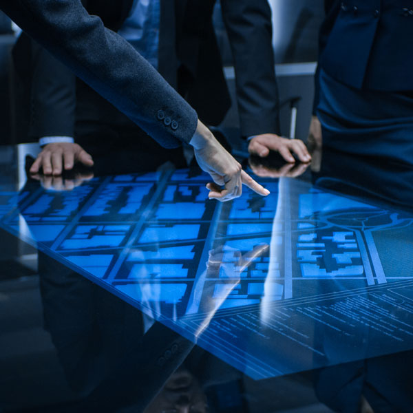 men pointing at graphic of city map